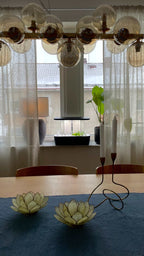 Smoothcrops Hydrowave hydroponic system on kitchen counter, elegant black design for 12 plants.